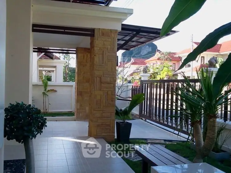 Charming garden entrance with lush greenery and modern design in a residential property.
