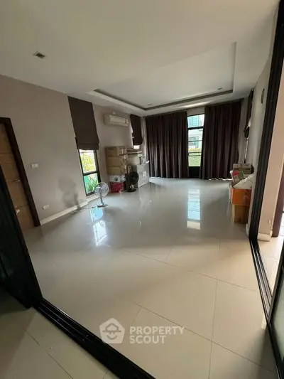 Spacious unfurnished living room with large windows and modern design.