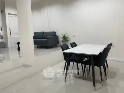 Modern dining area with sleek table and chairs in a stylish open layout