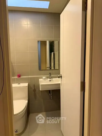 Modern bathroom with sleek fixtures and neutral tiles