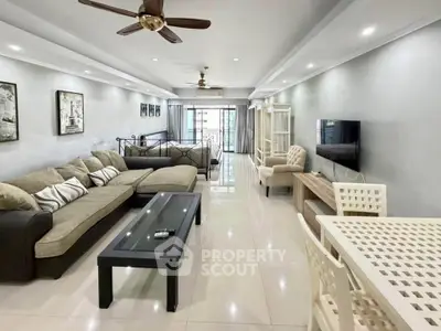 Spacious modern living room with elegant decor and large windows for natural light.