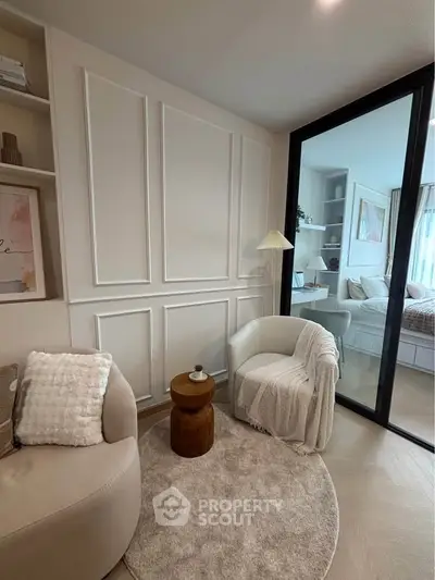 Cozy living room with elegant decor and sliding glass door to bedroom