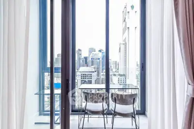 Modern balcony with stunning city view and glass table set