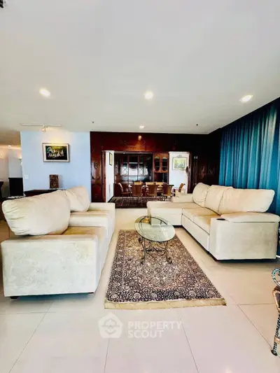 Spacious living room with plush sofas and elegant decor, perfect for relaxation and entertaining guests.