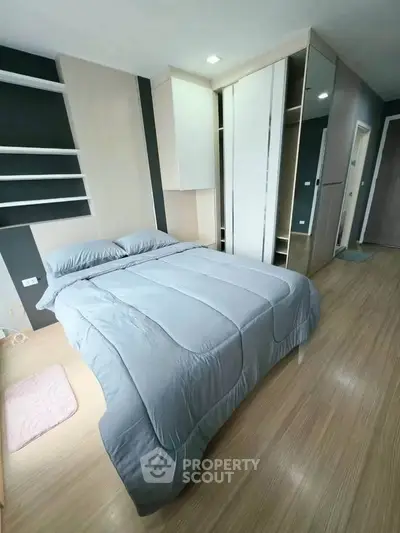 Modern bedroom with sleek design and ample storage in a stylish apartment.