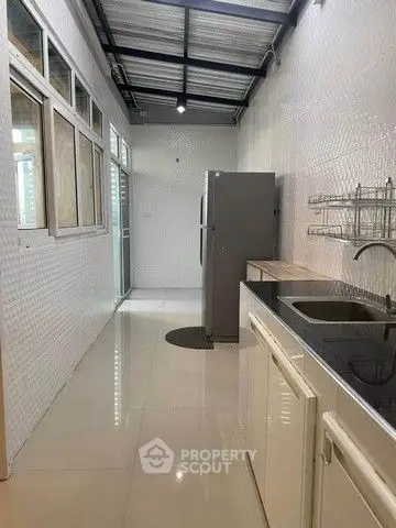 Spacious kitchen with modern appliances and sleek design in a bright, airy layout.