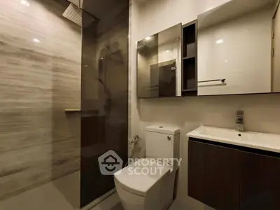 Modern bathroom with sleek fixtures and glass shower enclosure