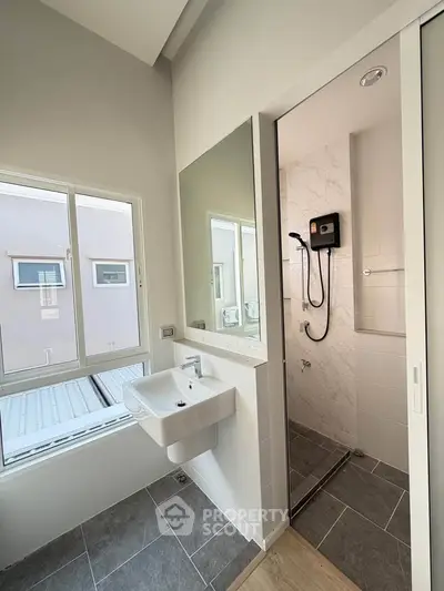 Modern bathroom with sleek design and large window for natural light