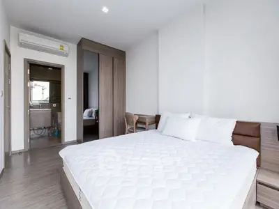 Modern bedroom with ensuite bathroom and stylish wooden furniture