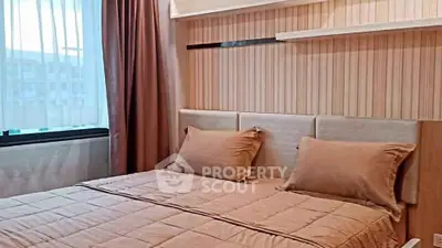 Cozy bedroom with elegant decor and natural light, perfect for relaxation and comfort.