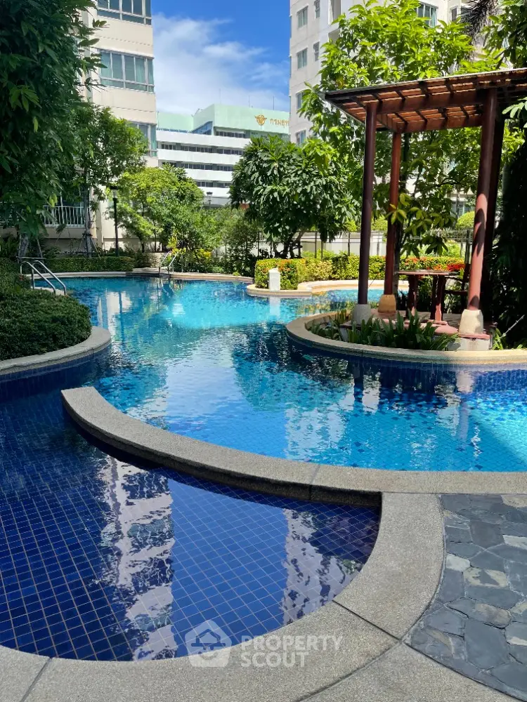 Luxurious residential pool area with lush greenery and modern design
