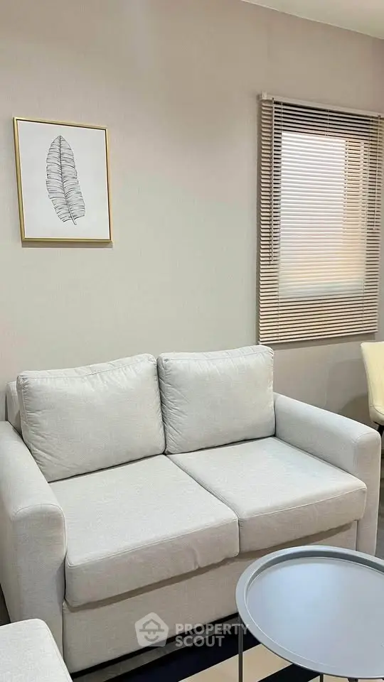 Cozy living room with modern sofa and stylish decor, perfect for relaxation.