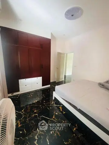 Spacious bedroom with elegant marble flooring and modern furnishings