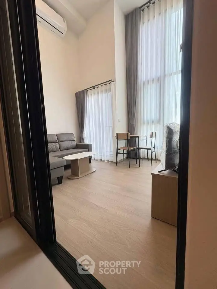 Modern living room with high ceilings and stylish furniture