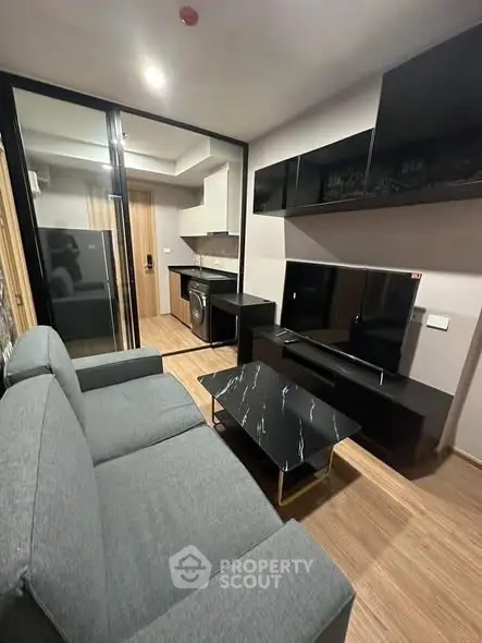 Modern living room with sleek furniture and open kitchen layout