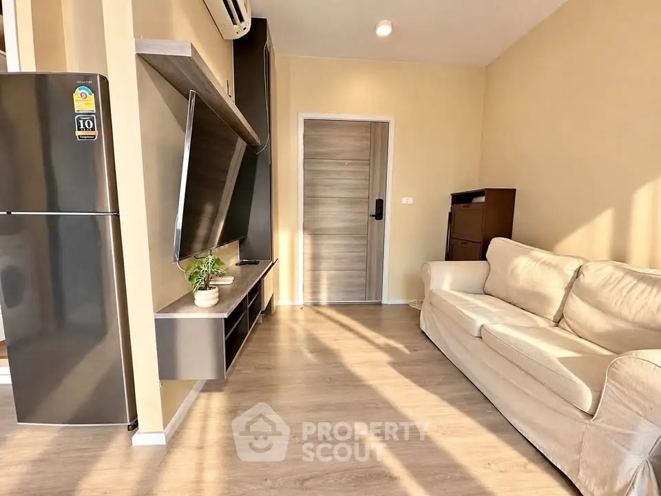 Modern living room with sleek design and natural light, featuring a cozy sofa and wall-mounted TV.
