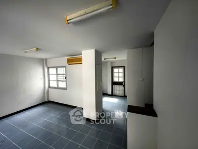 Spacious unfurnished room with tiled flooring and natural light, ideal for customization.