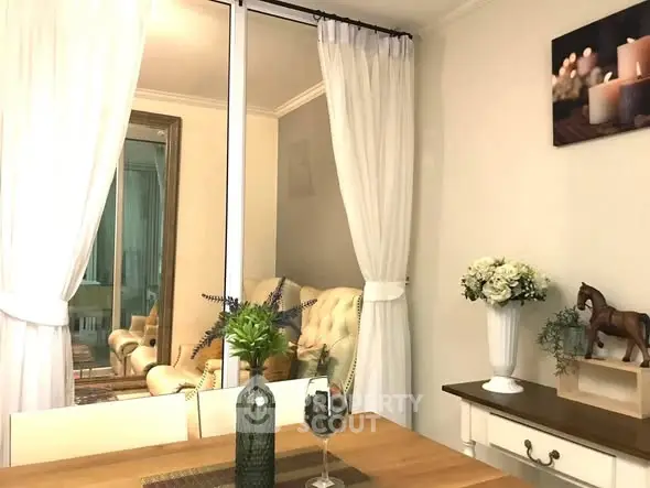 Charming dining area with elegant decor and cozy ambiance, featuring a stylish mirror and soft lighting.