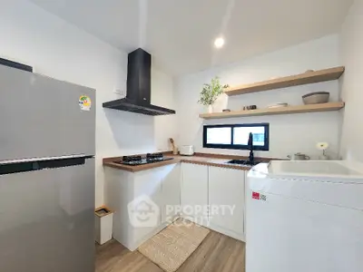 Modern kitchen with sleek appliances and open shelving in a compact layout