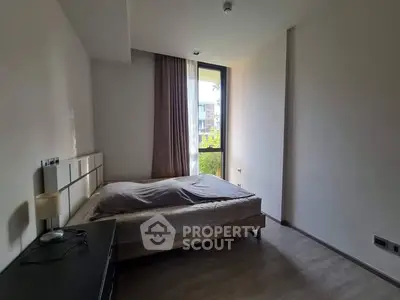 Cozy bedroom with natural light and modern decor in a stylish apartment.