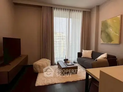 Modern living room with cozy seating and large window view