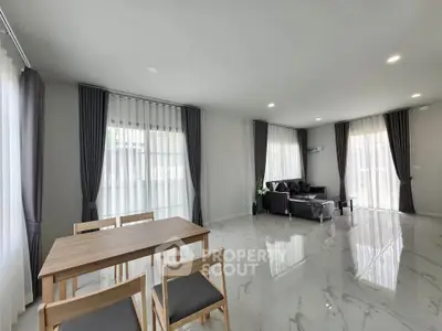 Spacious modern living room with elegant curtains and sleek furniture, perfect for family gatherings.
