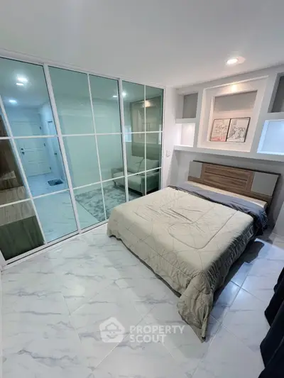Modern bedroom with sleek mirrored closet and stylish decor