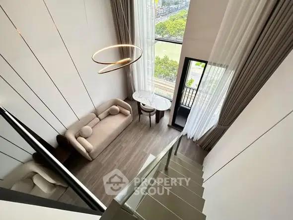 Stunning high-ceiling living room with modern decor and large windows offering a breathtaking view.