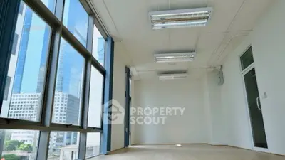 Spacious office space with large windows and city view, ideal for modern businesses.