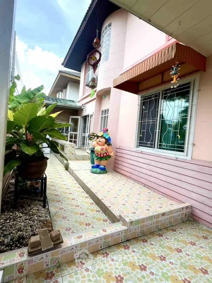 Charming exterior with colorful tiles and playful garden decor in a cozy residential setting.