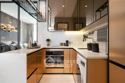 Luxurious modern kitchen with sleek cabinetry and built-in appliances in a stylish apartment.