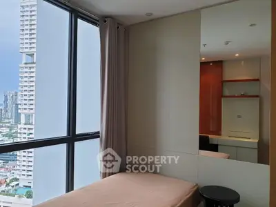Modern bedroom with large windows offering city views in a high-rise apartment.