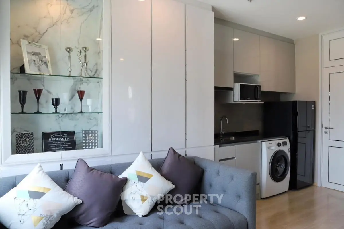 Modern living room with sleek kitchen appliances and stylish decor