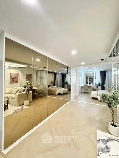 Spacious modern living room with mirrored wall and elegant decor