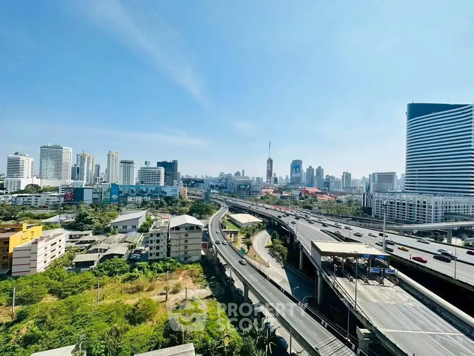 Stunning cityscape view from high-rise building showcasing urban skyline and major highway.
