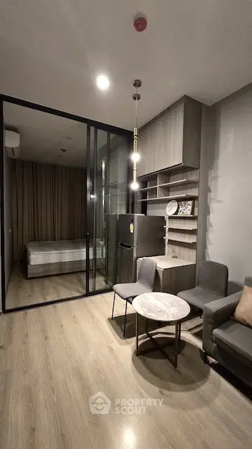 Modern living room with glass partition and cozy furniture