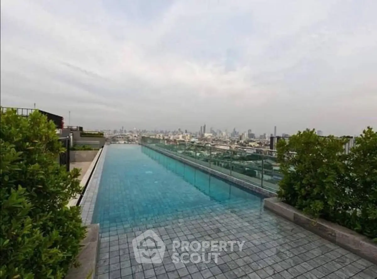 Stunning rooftop pool with panoramic city skyline view, perfect for luxury urban living.