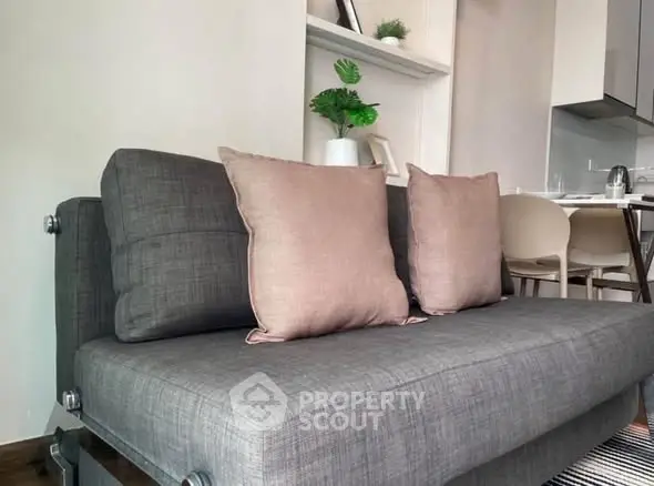 Modern living room with stylish gray sofa and cozy dining area