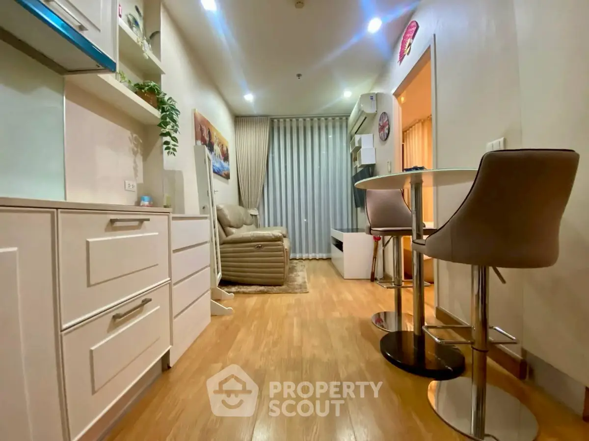 Modern living room with stylish furniture and open layout, featuring a cozy seating area and dining space.