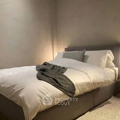 Cozy bedroom with modern bed and soft lighting, perfect for relaxation.