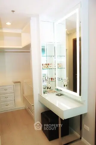 Luxurious walk-in closet with elegant vanity and ample storage space