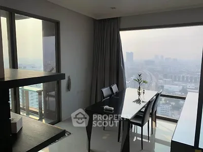 Stunning dining area with panoramic city views and modern furnishings in a high-rise apartment.