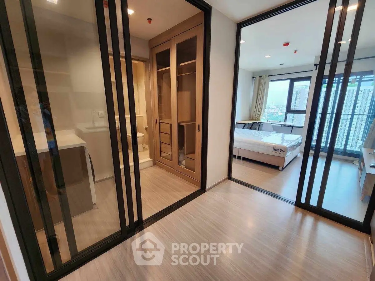 Modern apartment interior with glass sliding doors and city view