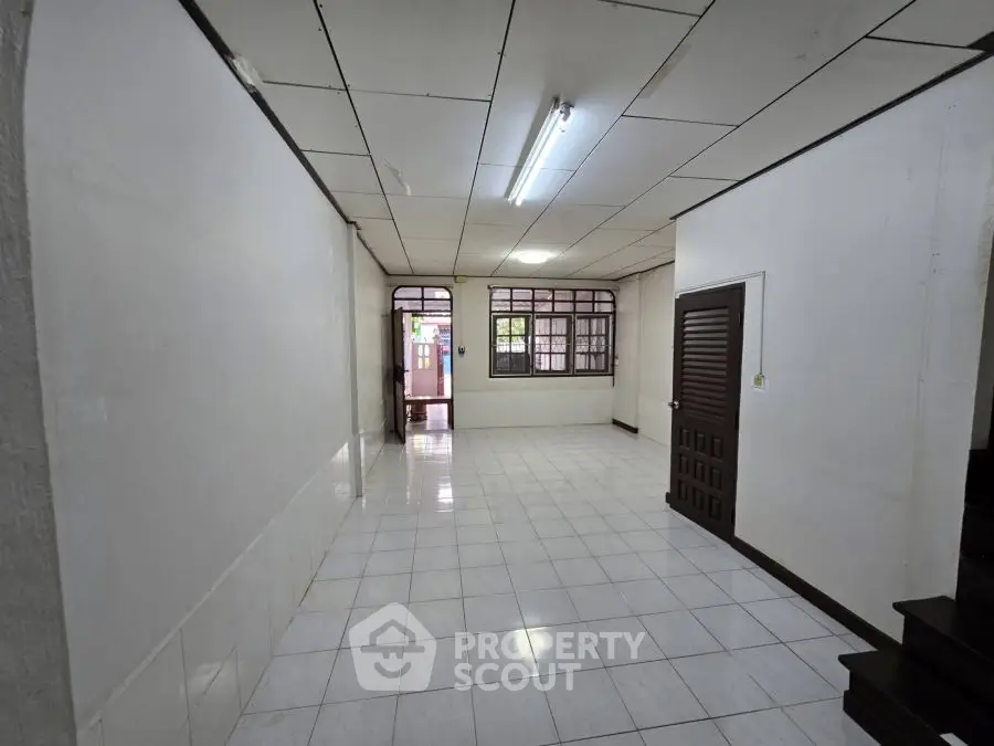 Spacious interior with tiled flooring and large windows in a minimalist design