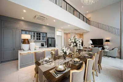 Luxurious open-plan living and dining area with elegant decor and high ceilings