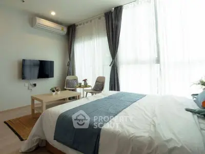 Modern bedroom with large windows and stylish decor