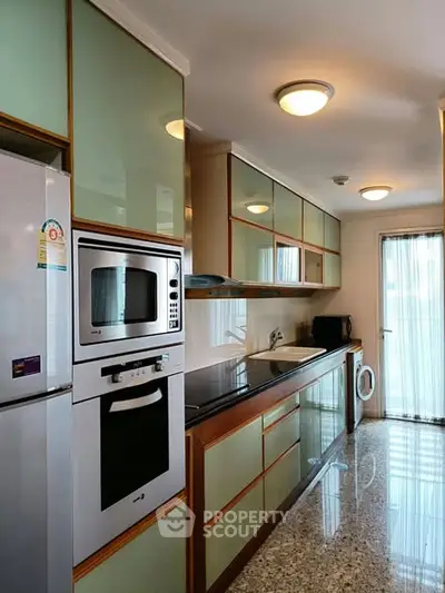 Modern kitchen with sleek appliances and ample storage space