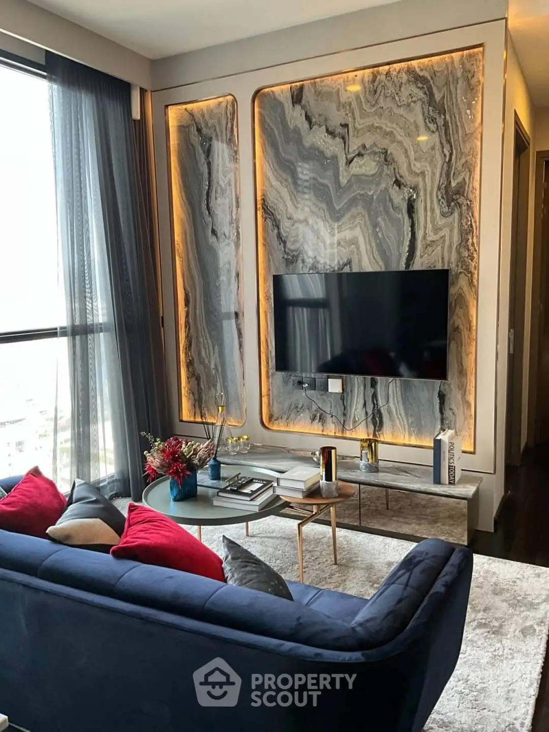 Luxurious living room with marble accent wall and modern decor