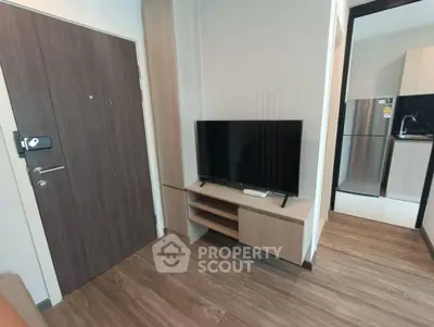 Modern living room with sleek TV stand and open kitchen view