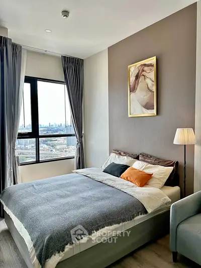 Modern bedroom with city view, stylish decor, and cozy ambiance in a high-rise apartment.